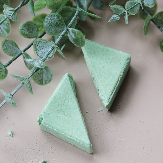 Esteam shower steamer with eucalyptus on a green lotus holder tray