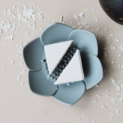 Esteam shower steamer in a white lotus holder tray with coconut