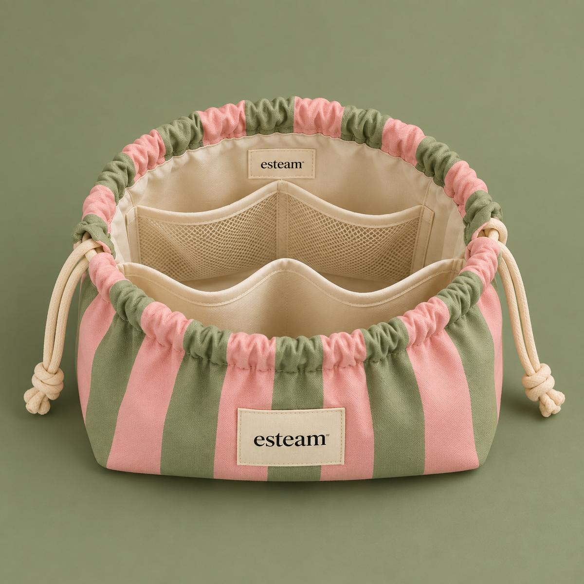 Esteam pink and sage striped make-up bag open, showing mesh pockets and padded dividers