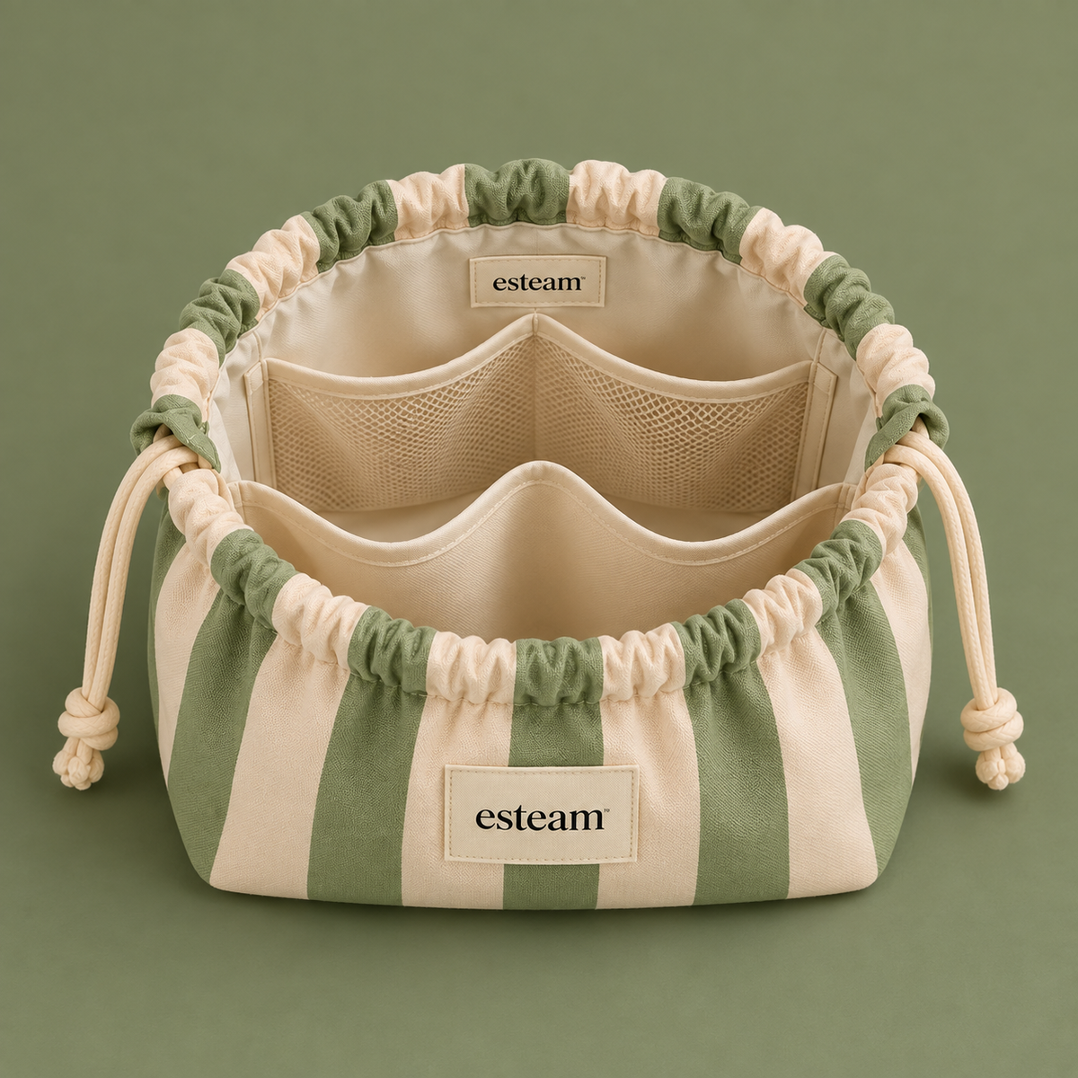 Esteam sage and cream striped make-up bag open, showing mesh pockets and padded dividers