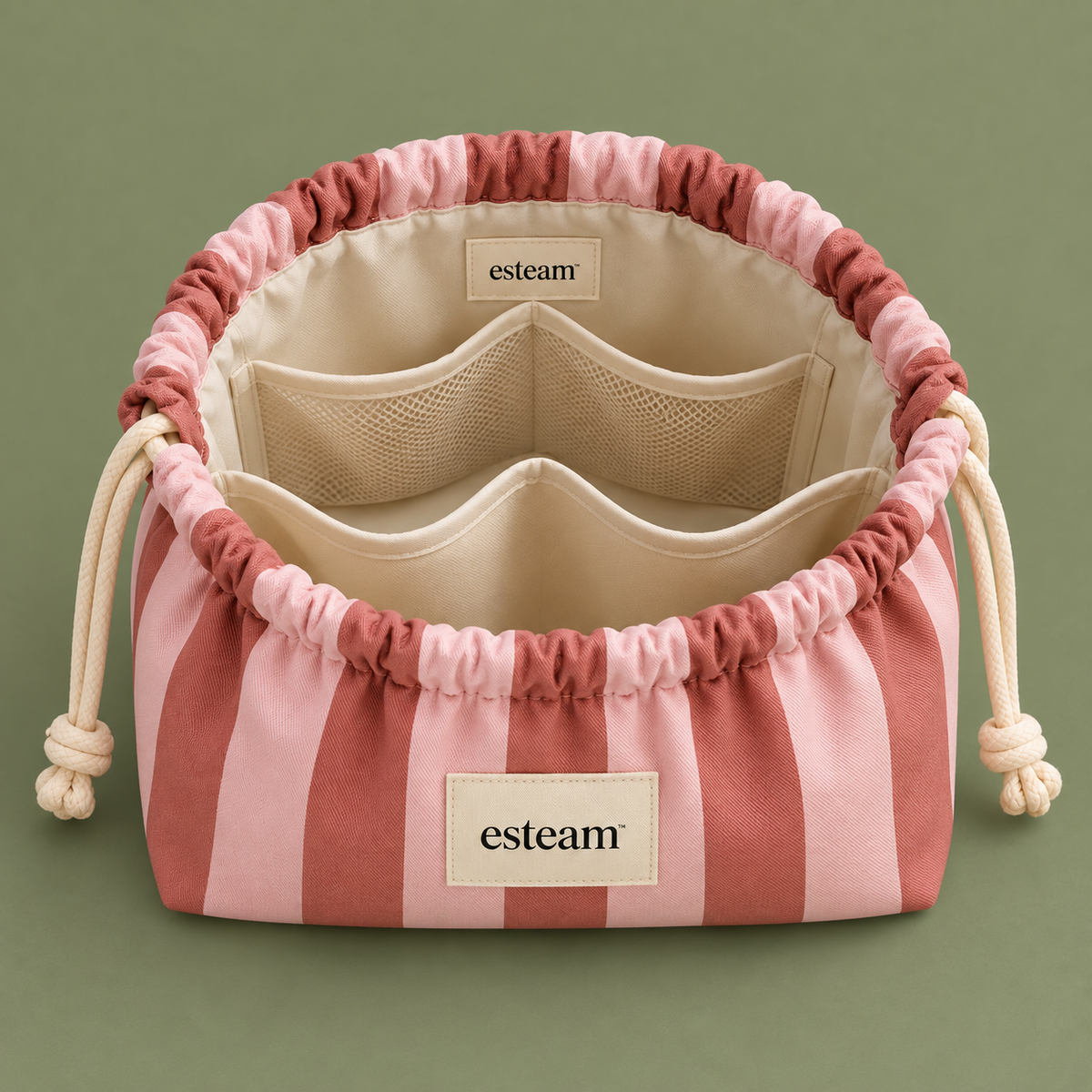 Esteam rose and blush striped make-up bag open, showing mesh pockets and padded dividers