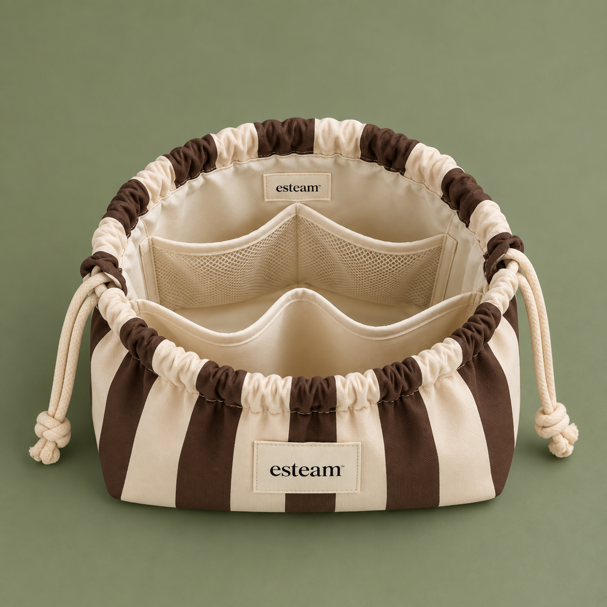 Esteam cocoa and cream striped make-up bag open, showing mesh pockets and padded dividers